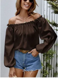 Detailed view of the elegant brown off-the-shoulder top highlighting its chic ruffled collar.