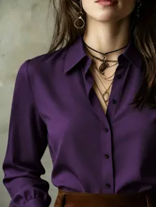Close-up of purple long-sleeve button-up blouse detail, elegant collar and lantern sleeve texture