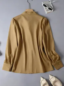 Elegant solid color long sleeve commuter blouse with chic collar and button cuff details.
