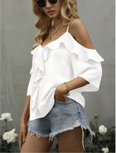 Close-up detail of the elegant white off-the-shoulder ruffle top paired with denim shorts.