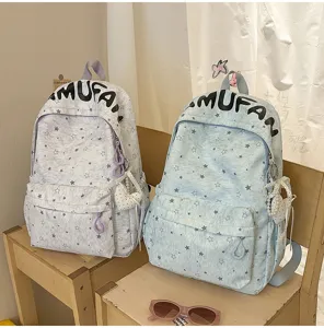 Detailed view of Korean style star pattern canvas school backpack with cute pearl heart pendant.