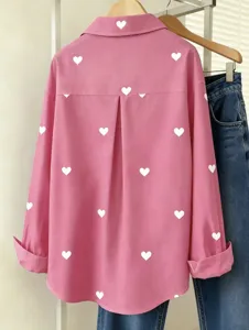 Pink long sleeve button down shirt with white heart print detail view design casual.