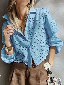 Detail shot of a light blue eyelet embroidered short sleeve button-up shirt for women