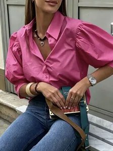 Detail view of the stylish pink puff-sleeve casual shirt with lapel and button closure.
