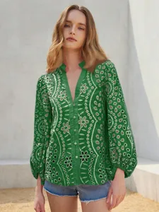 Detail shot of the green hollow embroidered lantern sleeve blouse, stylish and elegant.