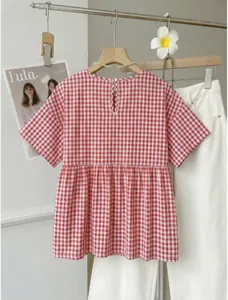 Red and white checkered short sleeve blouse detail with loose A-line hem and back button.