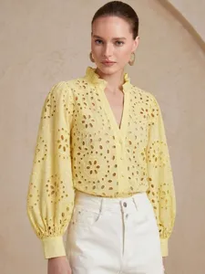 Detail view of the yellow eyelet embroidered long sleeve blouse with elegant ruffle stand collar.