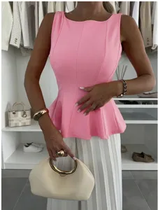 Sleeveless pink peplum top, tailored waist, elegant French style commuter summer wear.