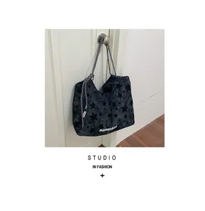 Detail shot of large capacity star print canvas tote bag with contrast rope handles.