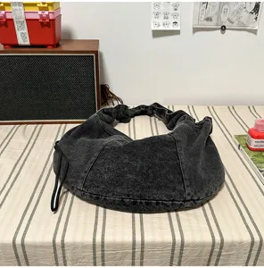 Detail shot of casual washed denim hobo bag, large capacity Korean style dumpling shoulder bag.