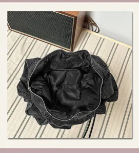 Large capacity black denim dumpling shoulder bag minimalist commuter design interior detail