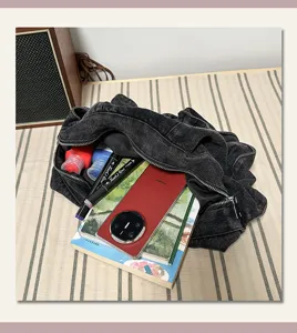 Casual large capacity denim dumpling bag for women, stylish minimalist commuter shoulder bag.