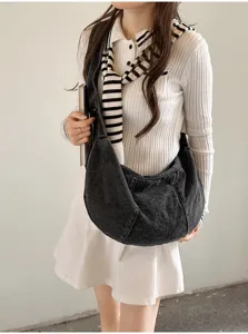 Detail shot of large capacity denim dumpling bag, Korean style simple casual commuting shoulder bag.