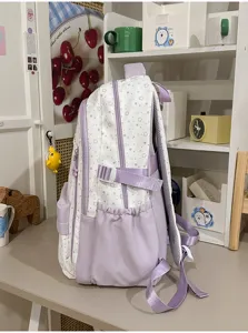 Purple and white star pattern school backpack with side pockets and adjustable straps