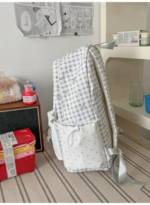 Sac à dos d'étudiant à motif de carreaux gris et poche avant pour l'école quotidienne.