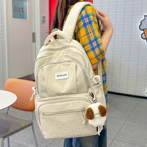 Cute polka dot canvas backpack for school girls, casual lightweight travel daypack bag.