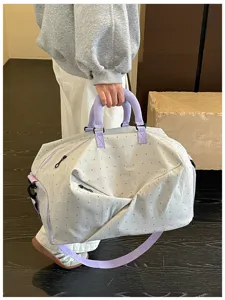 Detailed view of the large capacity travel duffel bag with stylish polka dot pattern.