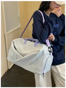 Large capacity travel duffel bag with cute polka dot bow pattern, portable shoulder bag for trip.
