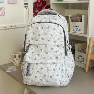 Sac à dos gris avec motif d'étoiles, cartable décontracté à larges bretelles pour étudiants.