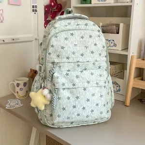 Sac à dos vert clair chiné motif étoiles, cartable stylé pour étudiants et usage quotidien.