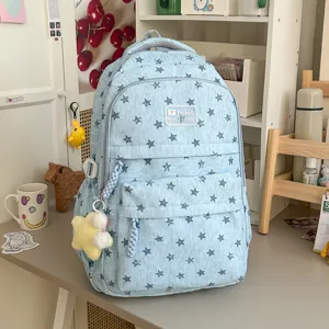 Sac à dos bleu style coréen avec motif étoiles et pendentif pour les étudiants et élèves.