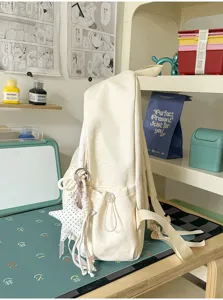 Sac à dos d'étudiant en toile décontracté avec pendentif étoile, léger et grande capacité.
