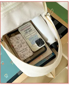 Sac à dos d'école en toile blanche décontracté avec une grande capacité et rangement.