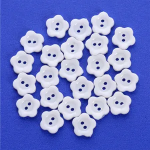 White flower-shaped two-hole buttons for sewing, crafts, clothing accessories, and DIY projects.