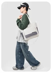 Casual canvas shoulder bag for men, large capacity campus style student messenger tote.