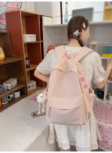 Casual pink canvas backpack for women, large capacity cute school bag for daily commute and travel.