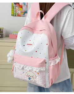 Mochila escolar rosa bonita con estampado de estrellas, ribete de encaje y colgante de perrito.