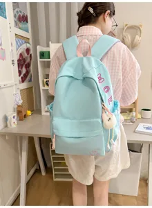 Lightweight solid color backpack with cute bow detail, large capacity for daily school and commute.