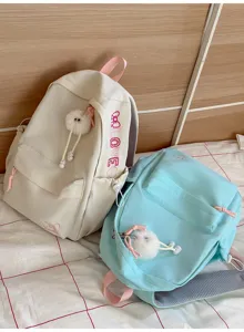 Korean style aesthetic solid color backpack with cute plush pendant and large capacity for daily use.