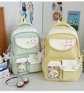 Close up scene of pastel Japanese style school backpacks with transparent pocket and charms.