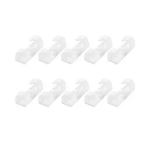 Detail shot of white plastic self-adhesive cable clips, neat arrangement for tidy wire management.
