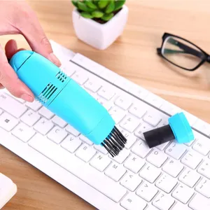 Portable mini USB keyboard vacuum cleaner with brush attachment for desktop cleaning tool.