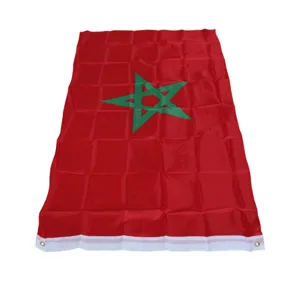 Detail view of Morocco flag with green star and brass grommets, fine fabric texture.