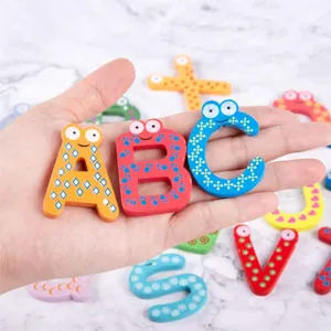 Wooden alphabet fridge magnets detail showing colorful letters with cute cartoon eyes design.