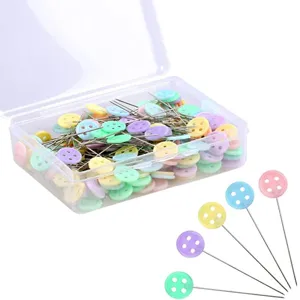 Close-up detail of colorful button head pins in a clear box for sewing and craft projects.