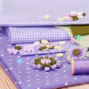 Detailed close-up view of decorative flower and button head pins for sewing, quilting, and crafting.