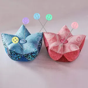 Fabric star pin cushion set with colorful button head sewing pins for craft quilting use.