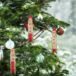 Detailed view of DIY wooden letter tiles forming words on Christmas tree hanging ornaments.
