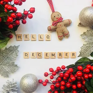 Wooden alphabet letter tiles detail shot with Christmas festive holiday decor arrangement.