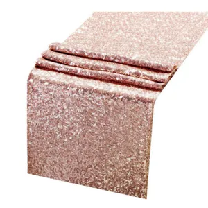 Rose gold sequin table runner detail shot, sparkling party decor fabric for wedding celebration.