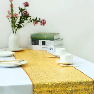 Golden sequin table runner detail view, sparkling wedding party table decor, elegant dining setup.