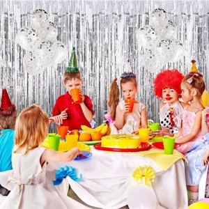 Party decoration set with silver foil fringe curtains, confetti balloons, and table runner.