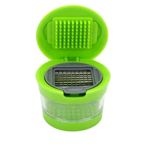 Manual garlic chopper with stainless steel grid and container for kitchen food preparation.