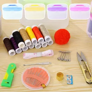 Vue détaillée du kit de couture portable avec bobines de fil colorées, aiguilles et boîte de rangement.