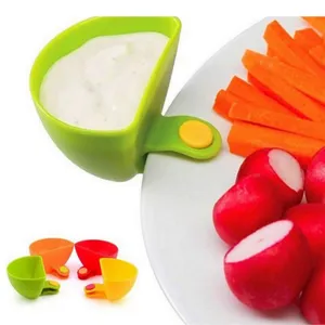 Kitchen clip-on dipping bowl detail showing how it easily attaches to plates for sauces and snacks.