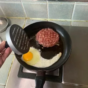 Aluminum burger press for making uniform meat patties with a sturdy plastic handle detail shot
